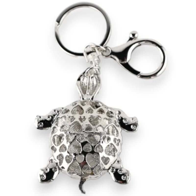 Porte-clés argenté en forme de tortue avec strass noir et blanc, design ajouré brillant
