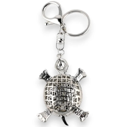 Porte-clés argenté en forme de tortue ornée de strass noir et blanc, avec anneau