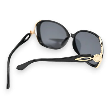 Lunettes de soleil noires grand modèle avec monture dorée, style élégant et classique